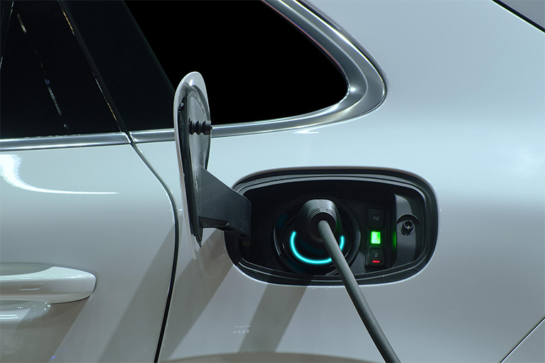 A close-up image of an electric car being charged.